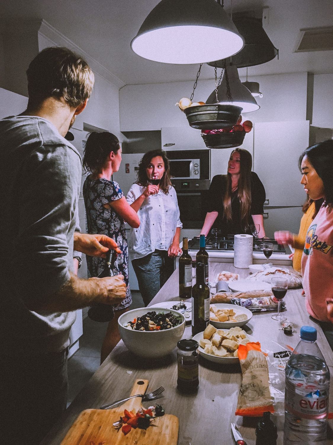Friends cooking and sharing Sonoma wine in a Healdsburg kitchen