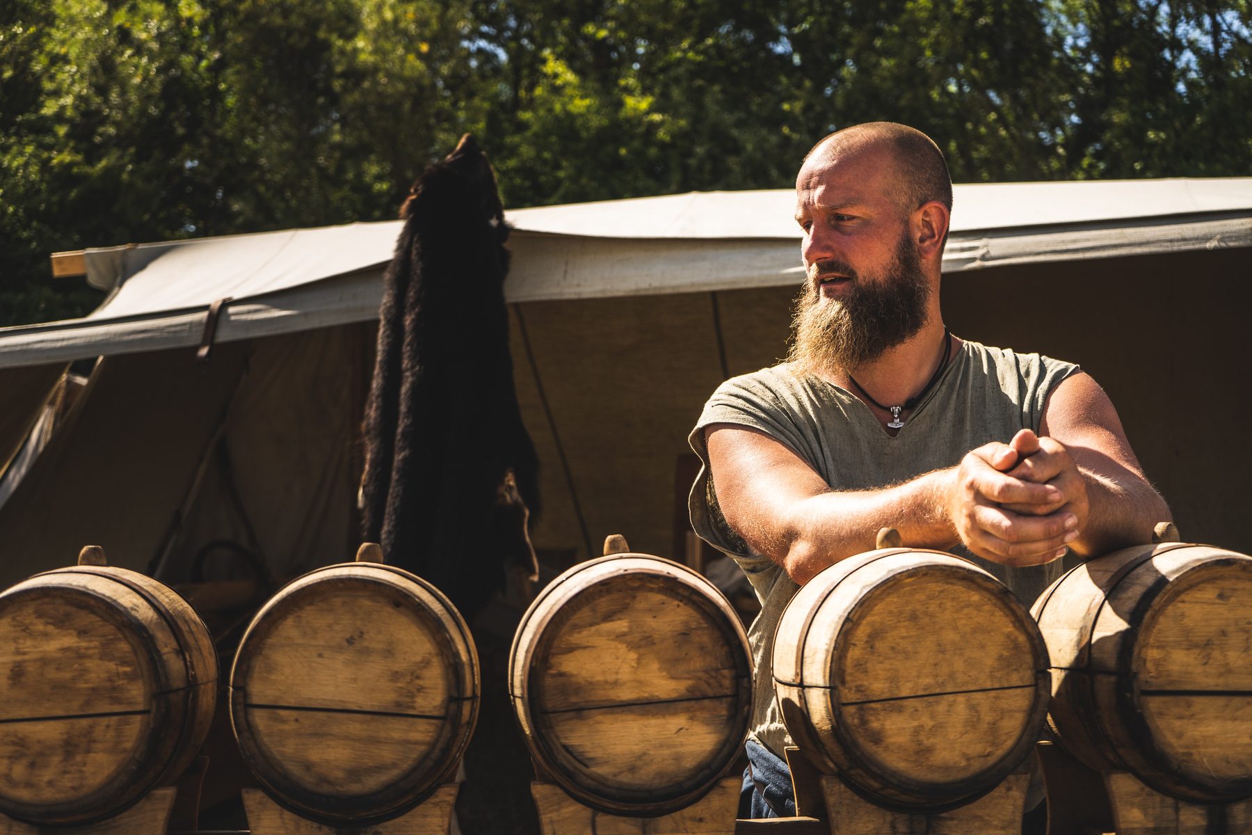 A winemaker working beside oak barrels at a small Sonoma winery